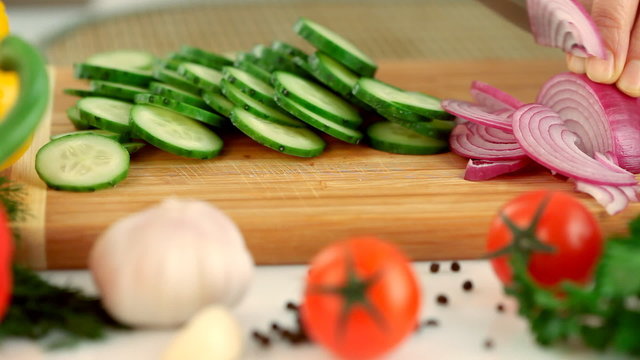 Female hands chopping Red onion