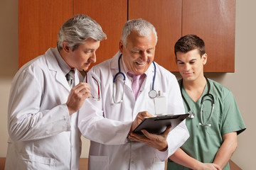 Senior Male Doctor With Colleagues