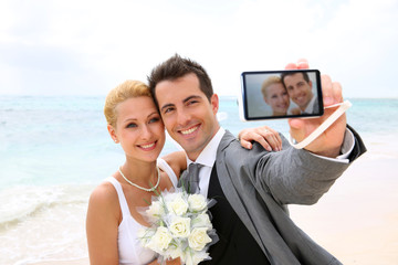 Bride and groom taking picture of themselves