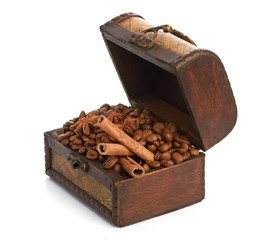 coffee beans and cinnamon sticks inside a  chest