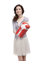 Young woman hands a birthday gift wrapped in red paper