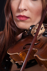 beautiful woman playing violin .