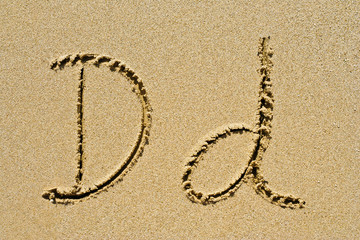 Alphabet letters D d handwritten in sand