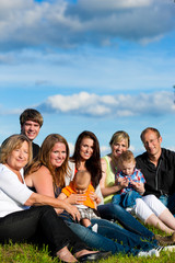 Fototapeta premium Family and multi-generation - fun on meadow in summer