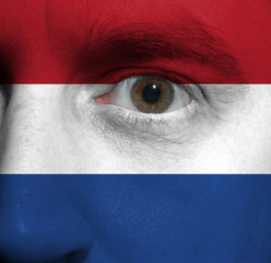 face with the Dutch flag painted on it