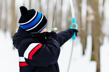 Boy shooting with the bow