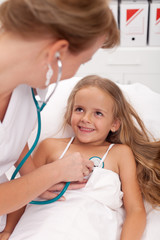 Healthcare professional checking up on little girl