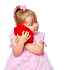 beautiful girl in a wreath holding a heart on a white background