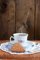 Heart shape Saint Valentine's Cookie and cup of coffee with stea