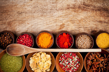 Various kind of spices in wooden bowls