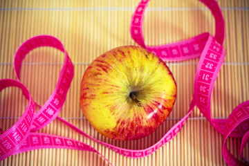 healthy diet: apple and measuring tape