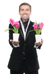 Handsome stylysh man presenting flowers