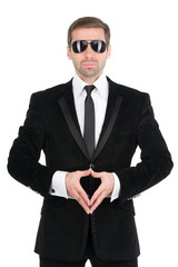 Stylish bodyguard with glasses and folded arms. Isolated