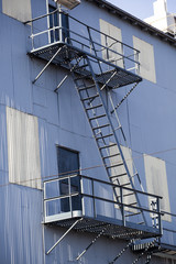 White Metal and Blue Metal Building with Fire Escape