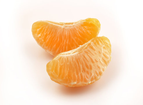 Two slices of tangerine on white background