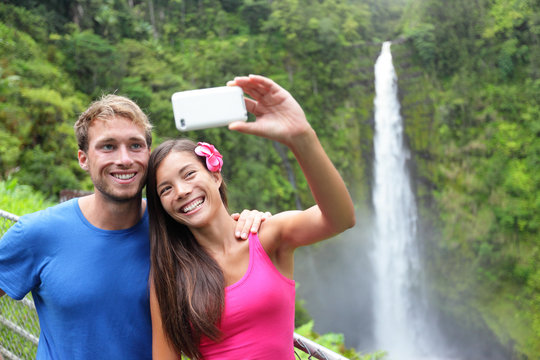 Couple tourists taking self portrait on Hawaii
