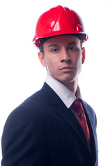 Portrait of handsome engineer with red hardhat