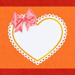 heart shape with a bow on textile background