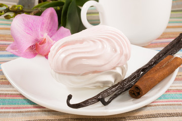 pink marshmallow on a saucer with a vanilla, cinnamon