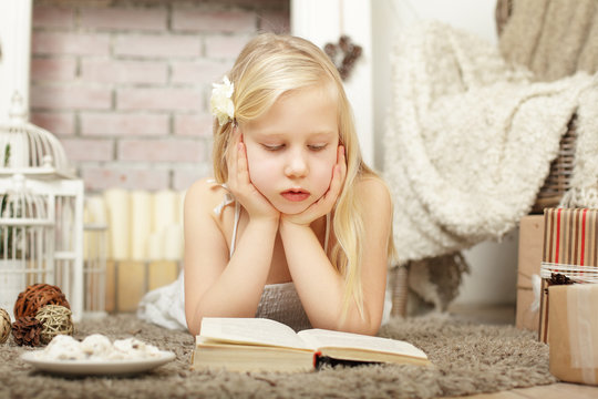 Child girl reading a book