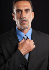 Businessman adjusting his tie