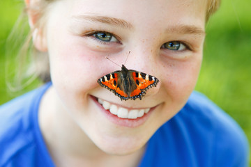 beautiful girl with a butterfly on her nose