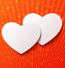Two paper hearts over red background