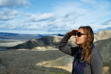 Girl at the foot of the mountains looking into the distance