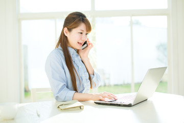 Beautiful asian businesswoman using a laptop computer