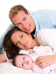 Baby girl mother and father family happy lying together