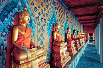 golden statues of Buddha in Wat Arun temple, Bangkok - obrazy, fototapety, plakaty