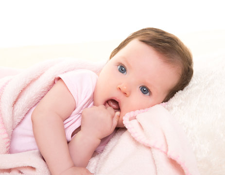 baby girl with toothache in pink with white fur