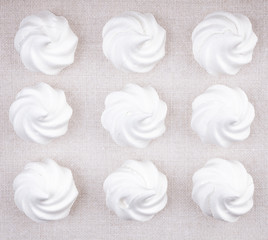 Top view of nine white meringue cookies