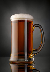 Mug of beer over black background