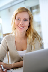 Smiling woman working from home on laptop