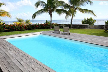 Private swimming pool in tropical area - obrazy, fototapety, plakaty