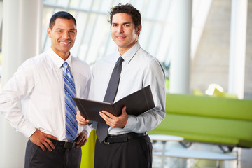 Businessmen Having Informal Meeting In Modern Office