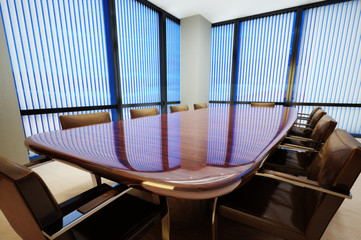 Business office conference room with table and leather chairs