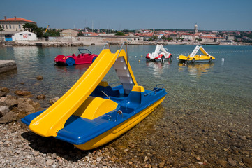 Blue and yellow pedalo boat on seaside at Krk - Croatia