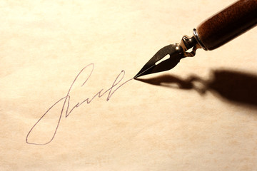 Closeup of signature (fake, not real) and ink pen, on old paper