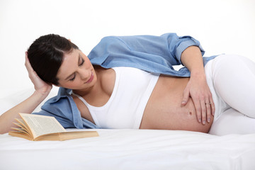 pregnant woman lying in her bed
