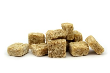 Brown cane sugar cubes isolated on white background