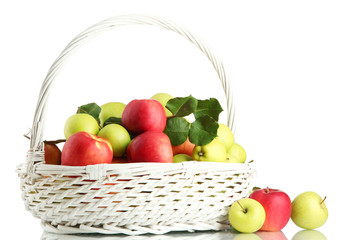 juicy apples with green leaves in basket, isolated on white