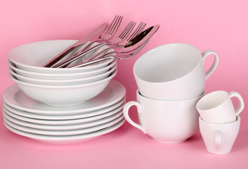 Clean white dishes on pink background