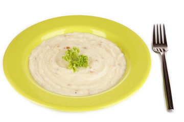 Mashed potatoes in green plate isolated on white