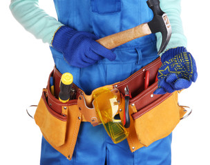 Male builder in blue overalls with gavel isolated on white