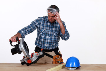 craftsman looking at his new electric saw