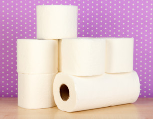 Rolls of toilet paper on purple with dots background