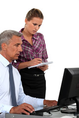 Obraz premium A boss and his secretary at work.