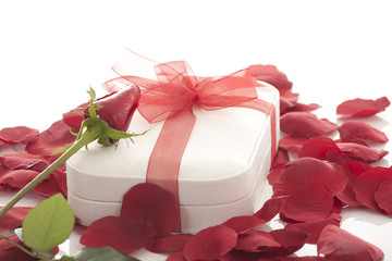 Valentines Day gift in red box with rose petal